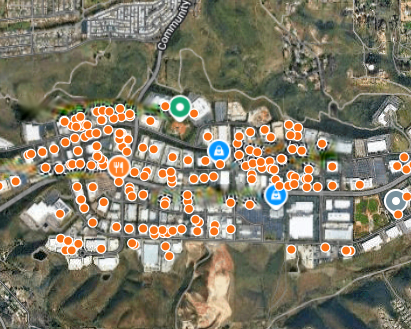 Satellite map of a commercial corridor with lead buildings marked by orange pins